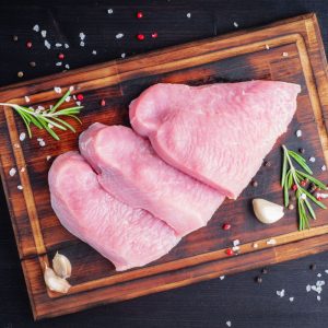 turkey-steak-raw-fillet-on-chopping-board-on-dark-KGMA5RV-scaled-e1632241355711